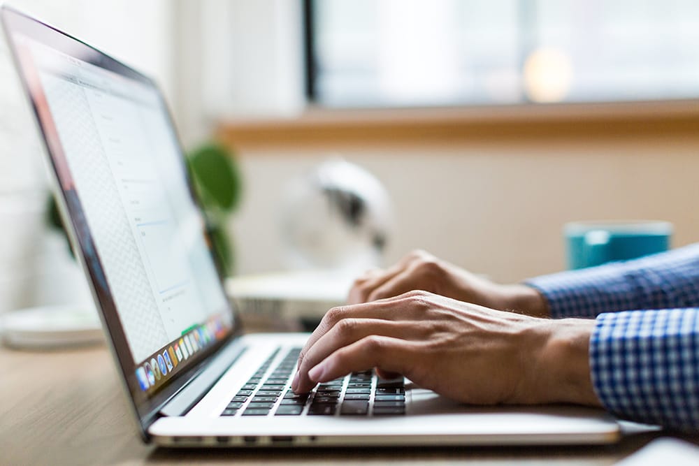 Person typing on laptop